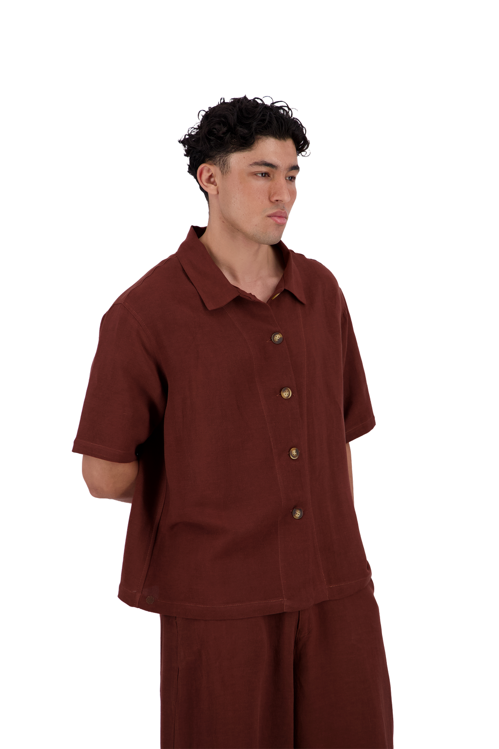 A man wearing a short-sleeve button-up shirt and matching pants in a solid rust-brown color, photographed against a solid white background. #Burnt_Clove