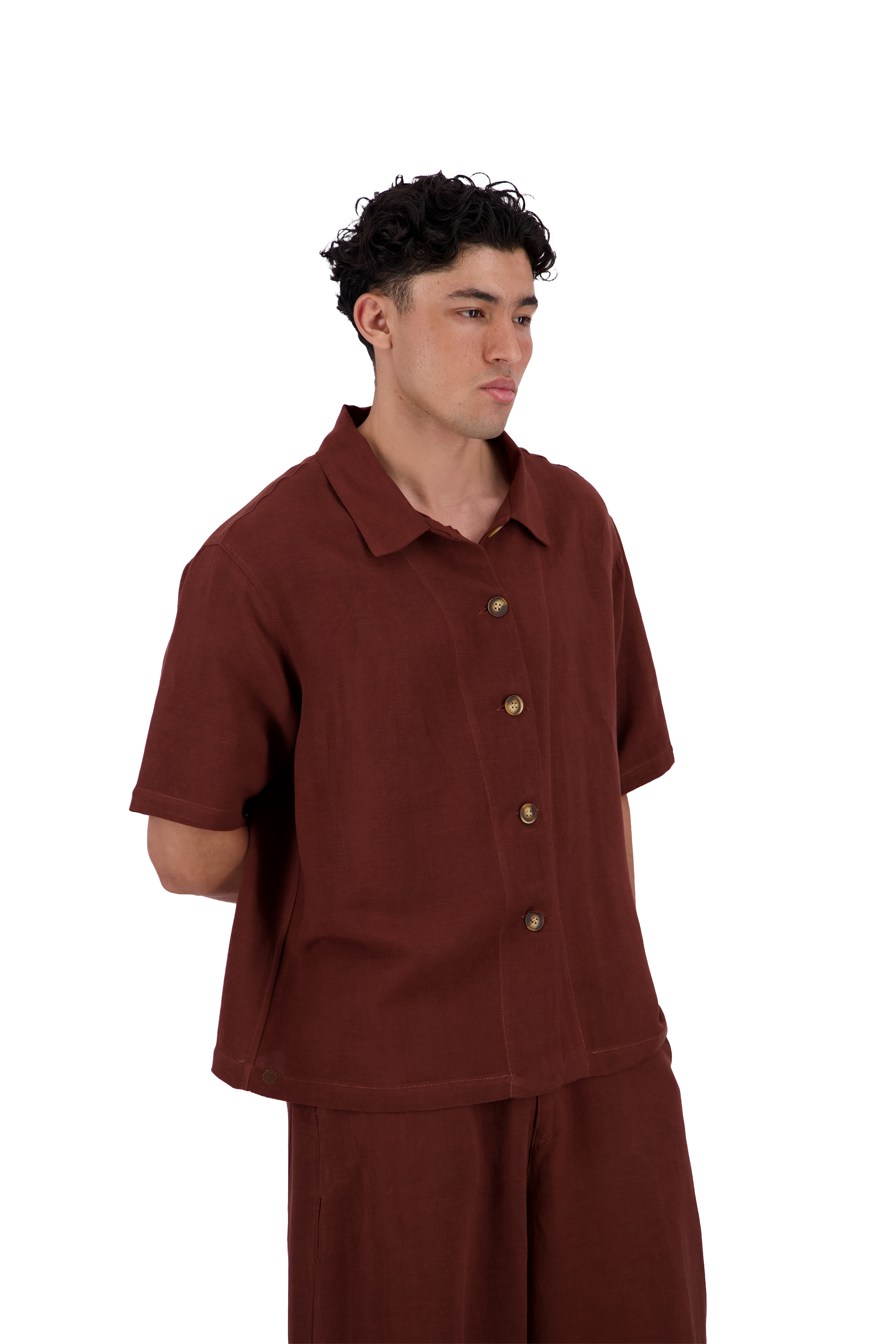 A man wearing a short-sleeve button-up shirt and matching pants in a solid rust-brown color, photographed against a solid white background. #Burnt_Clove