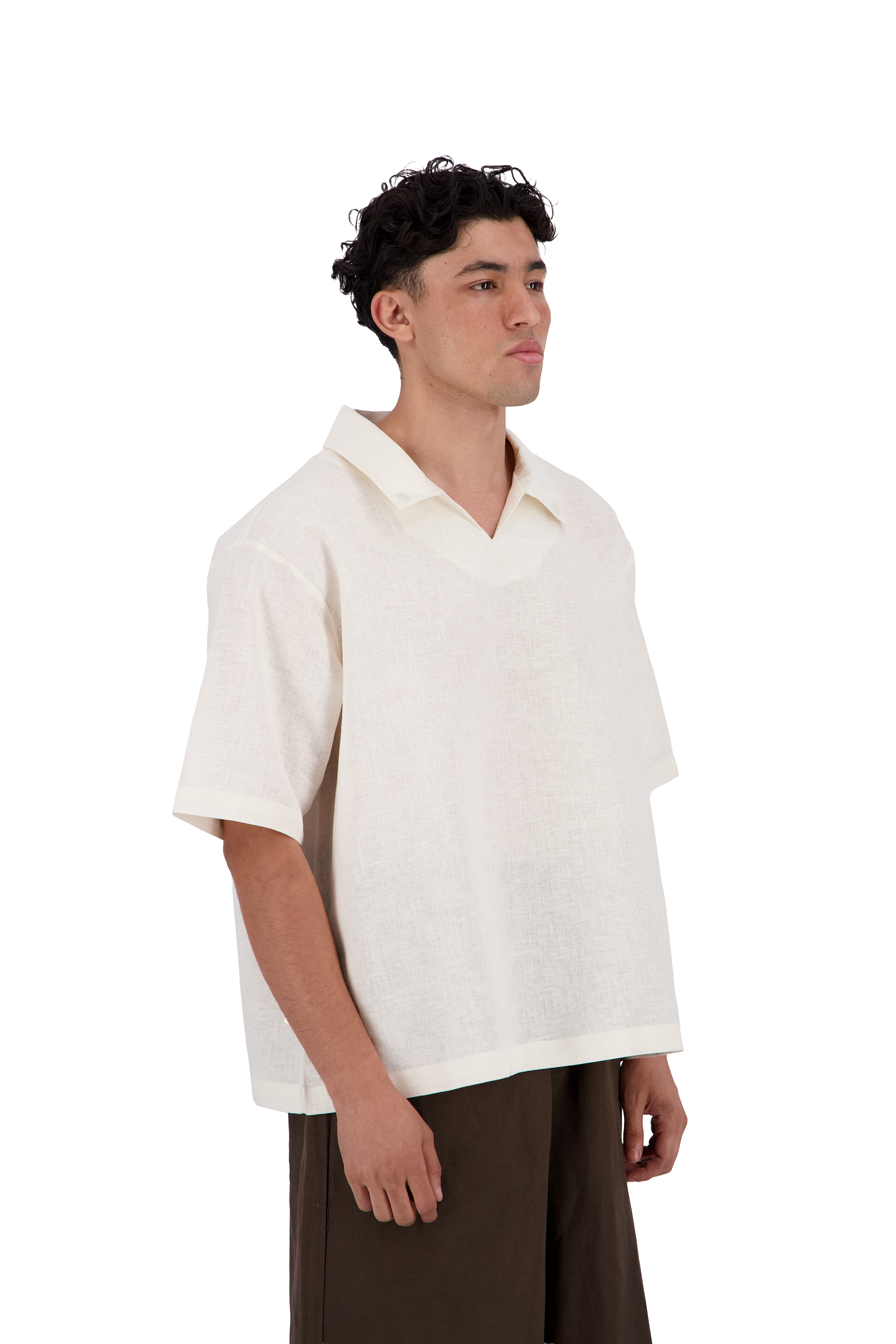 A man wearing a short-sleeve, v-neck knit polo shirt in off-white, paired with dark brown trousers, photographed against a solid white background. #Milk_Dune
